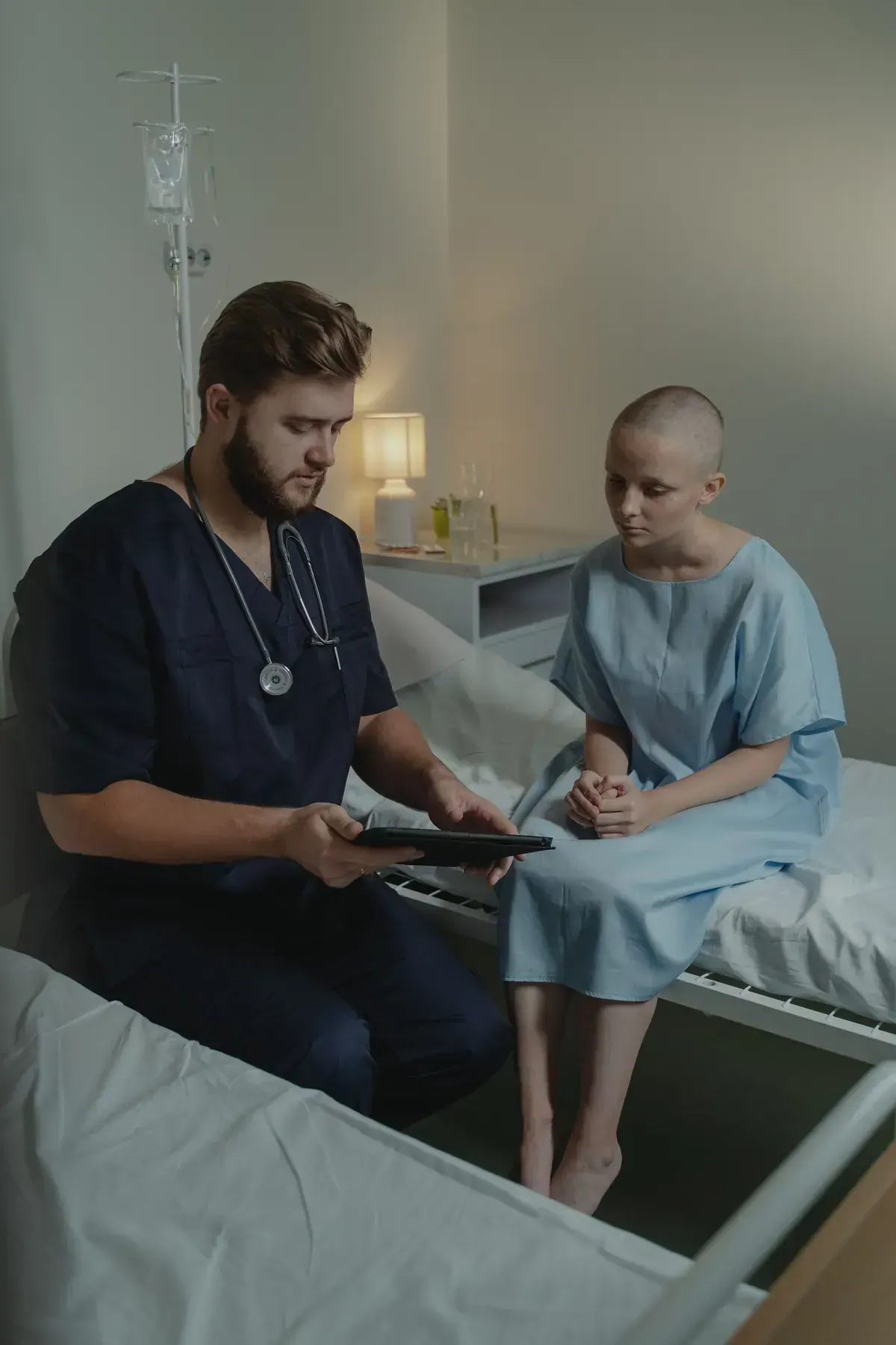 Nurse talking with and encouraging a patient in a hospital room