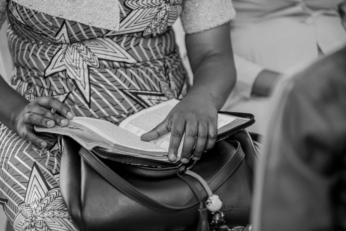 Woman reading an open Bible for quiet faith and recovery