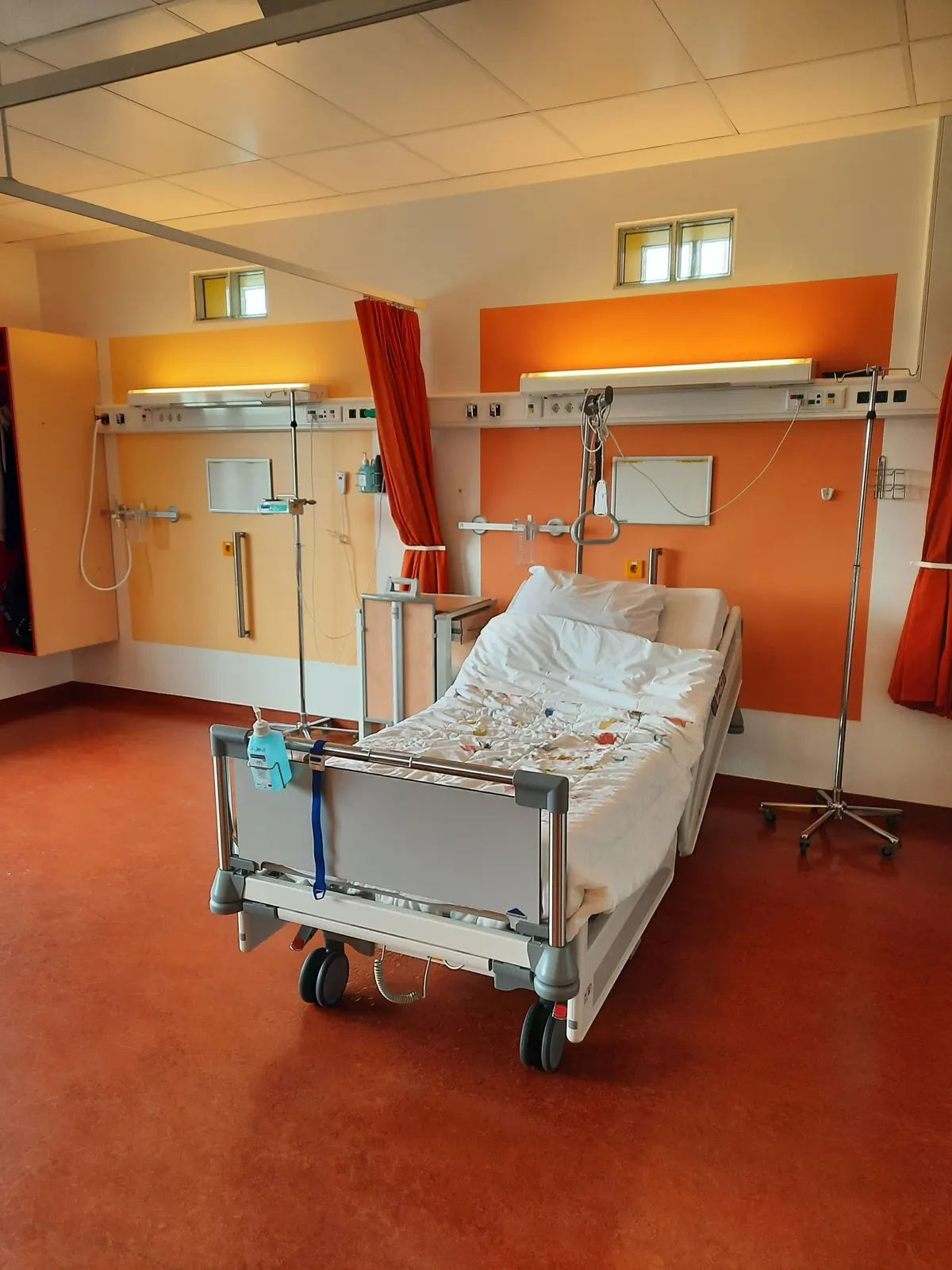 Quiet hospital room with an empty bed representing recovery and healing