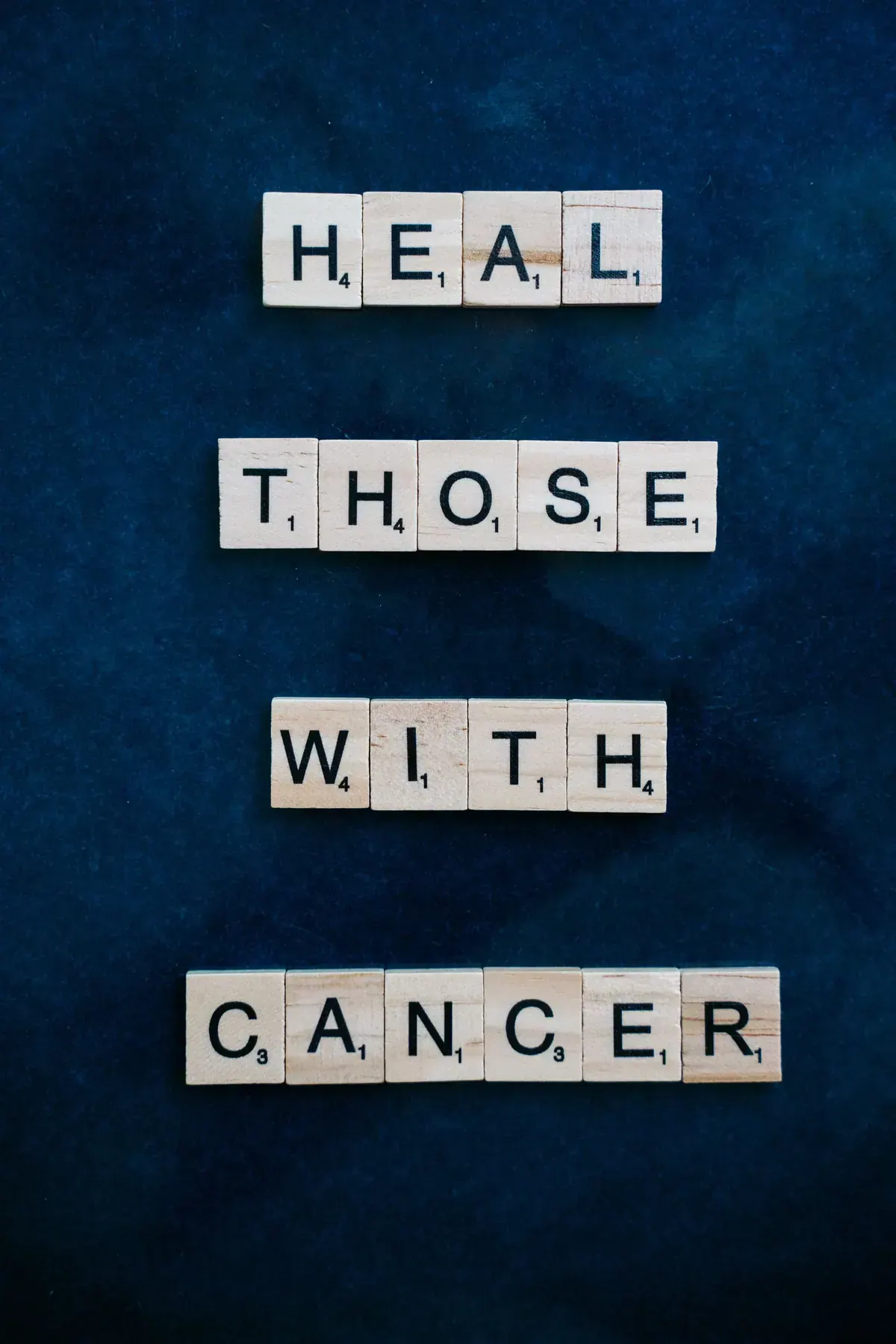 Hands lifted in prayer while reading healing scriptures during cancer treatment