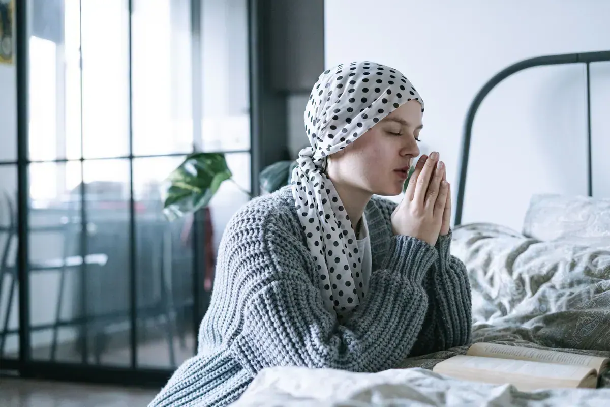 Person in quiet reflection and rest while holding onto hope during cancer care