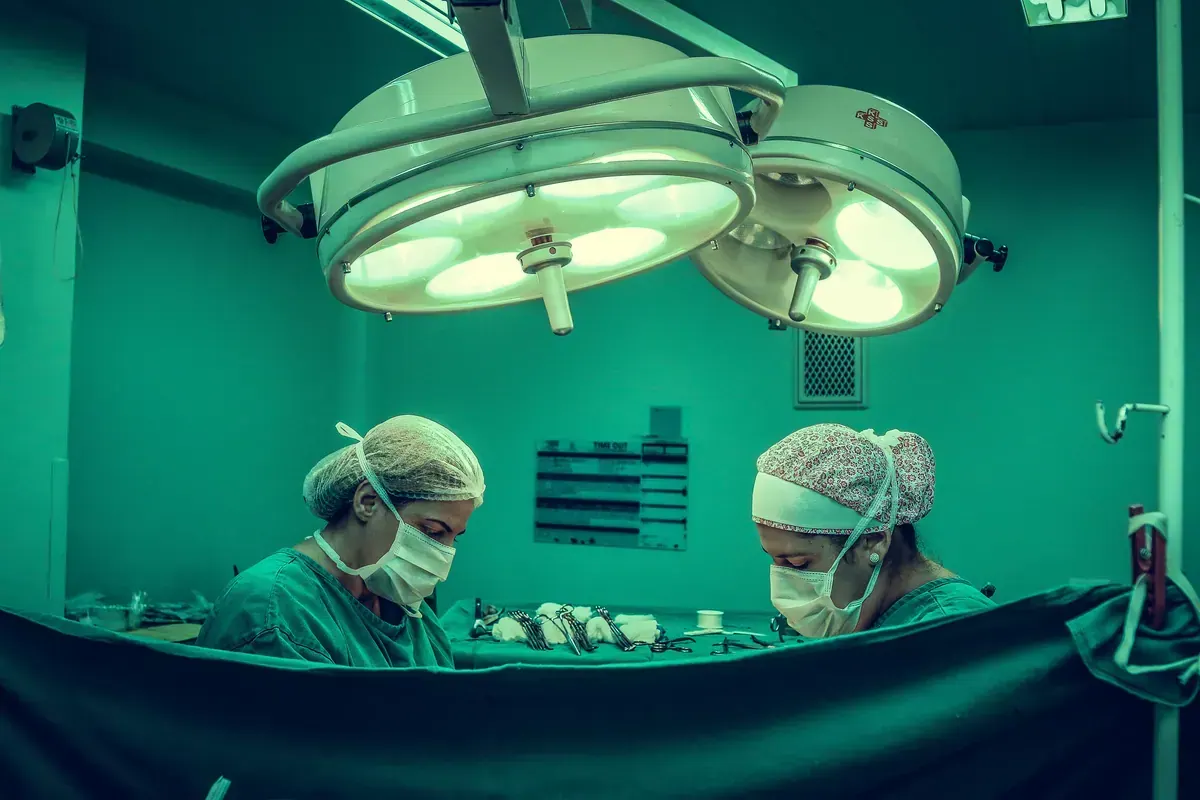 Holding hands in comfort and prayer during illness, reflecting care for the sick